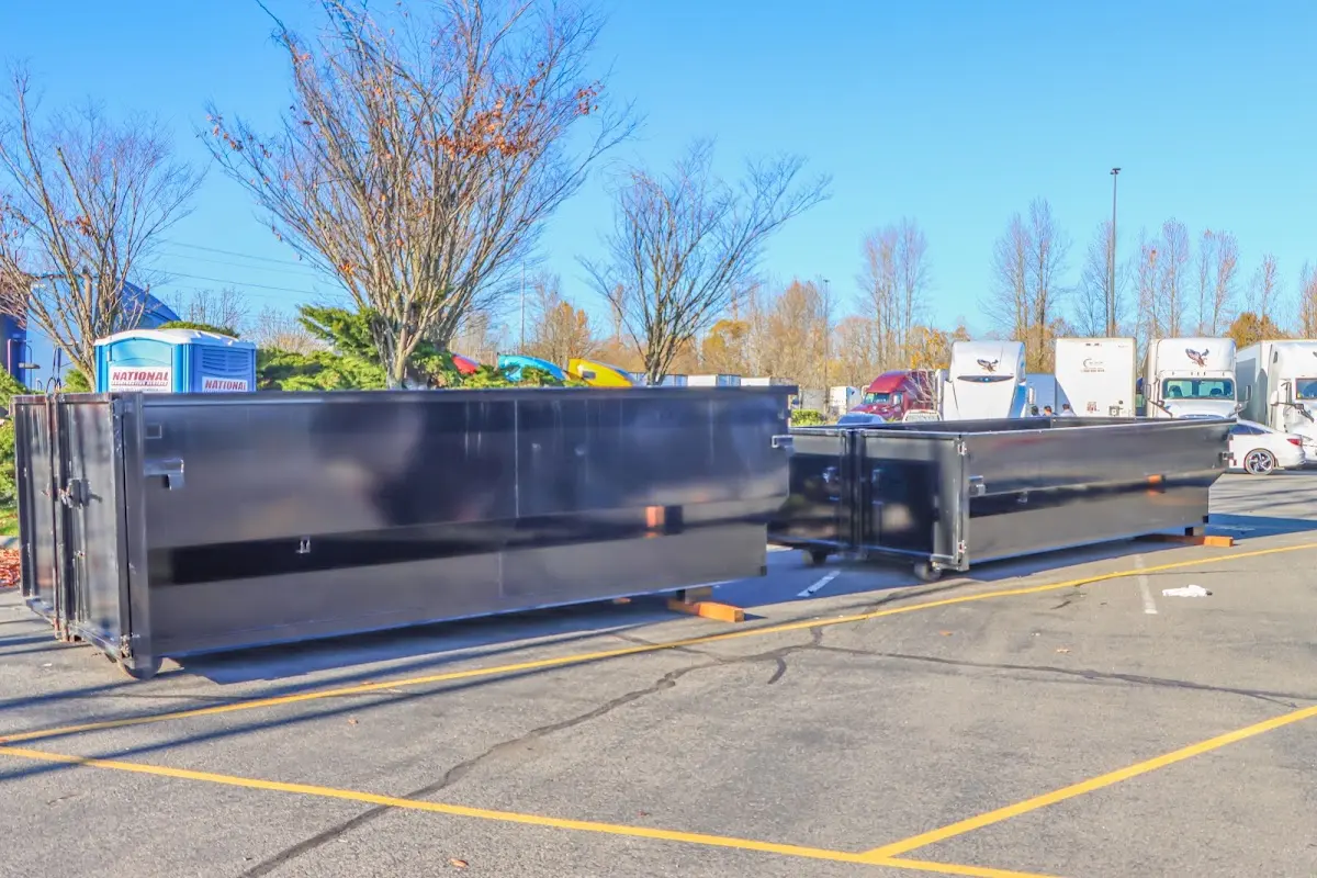 Professional dumpster rental service with roll-off container on residential driveway in Phoenixville